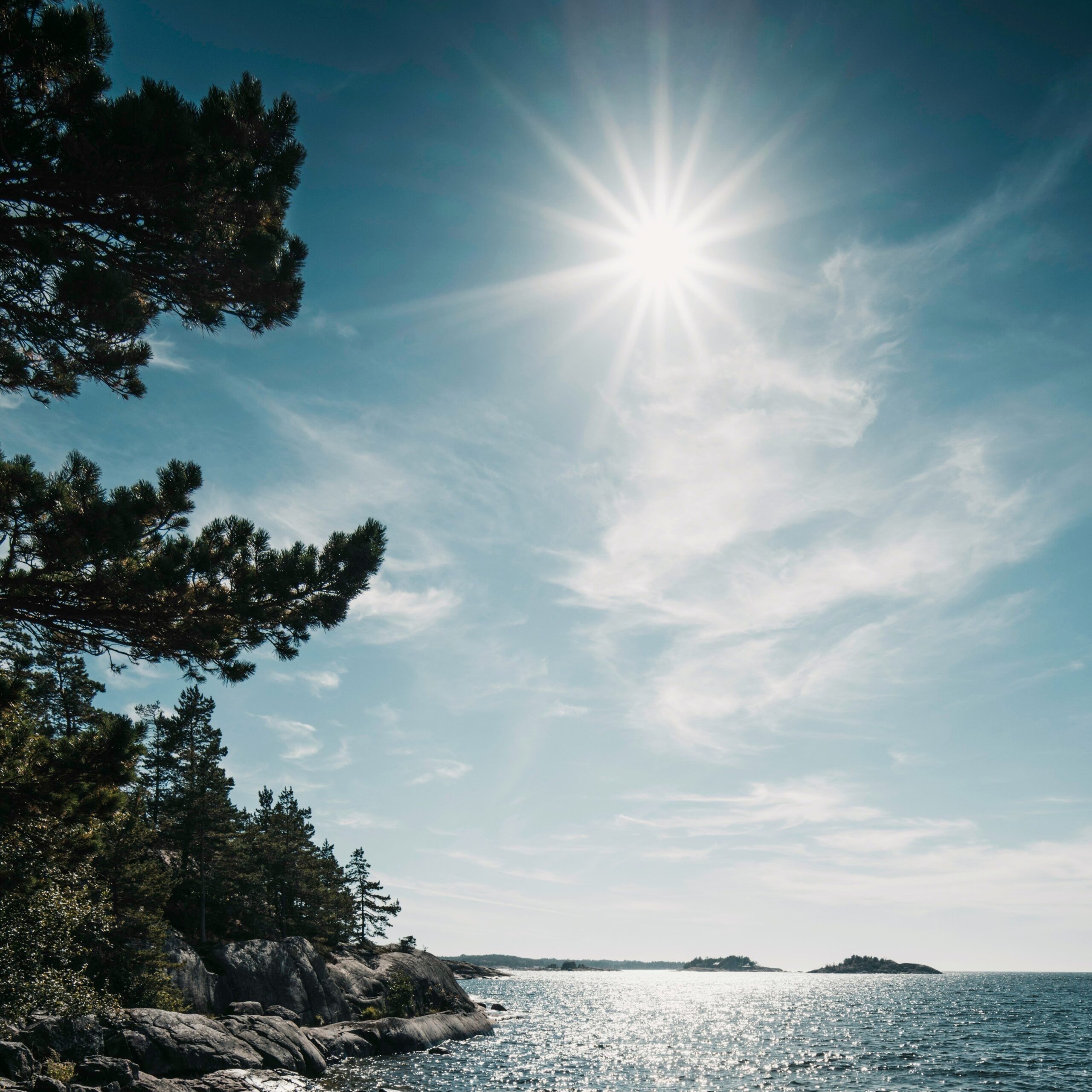 Klippor ut mot havet där solen lyser. 
